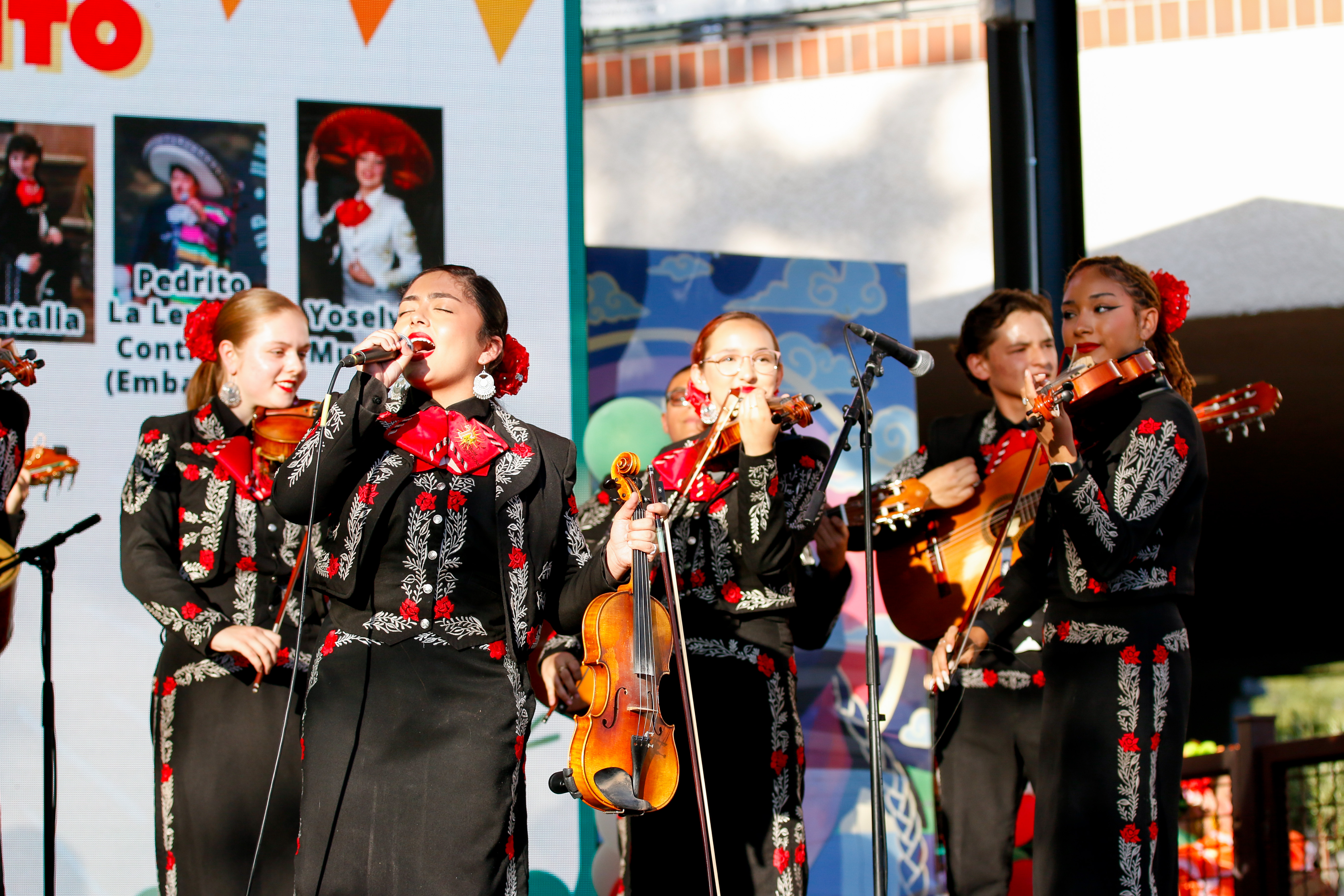 Mariachi Rayos del Sol performers sing during the celebration