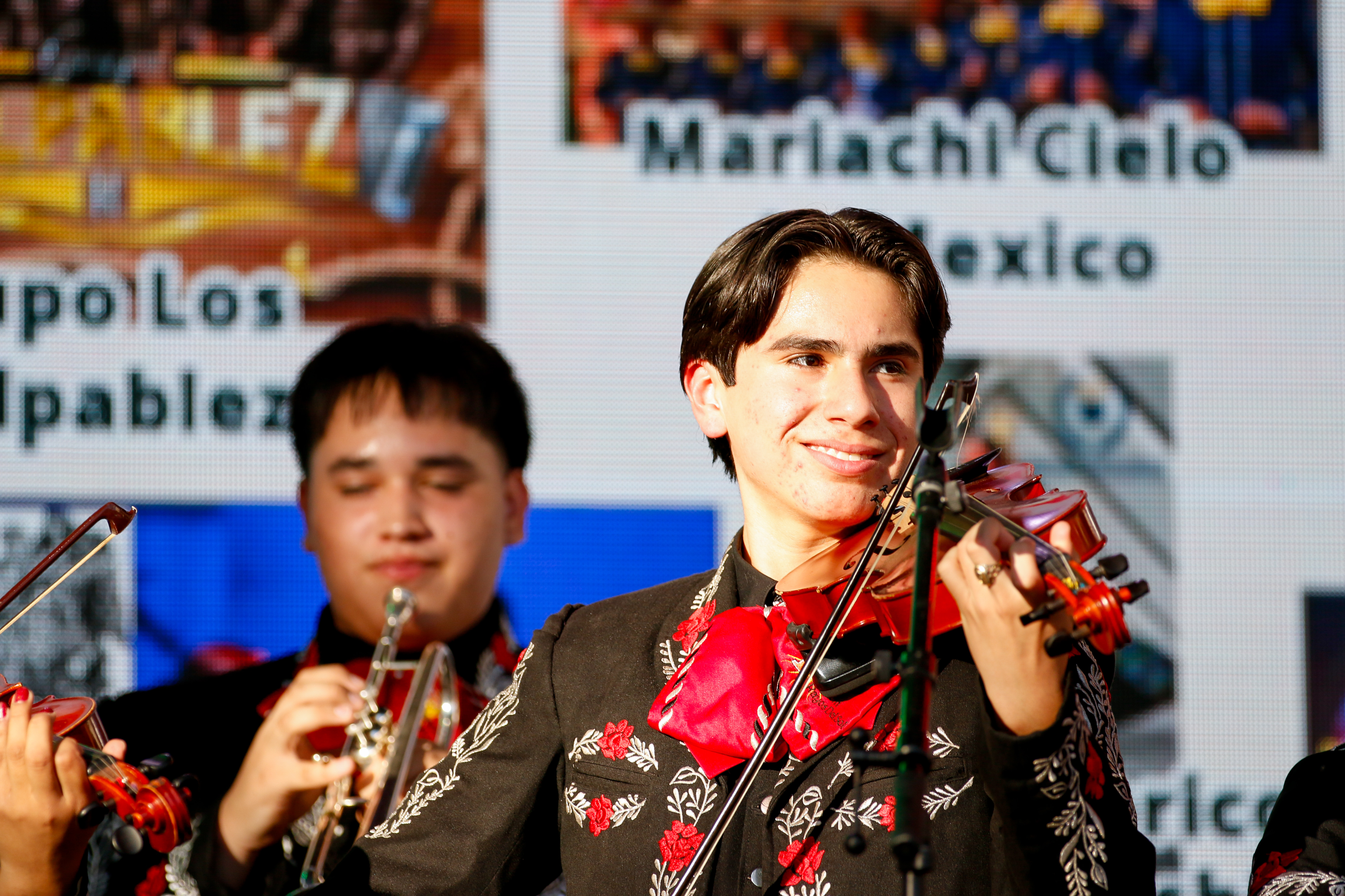 A member of Mariachi Rayos del Sol smiles while playing his violin