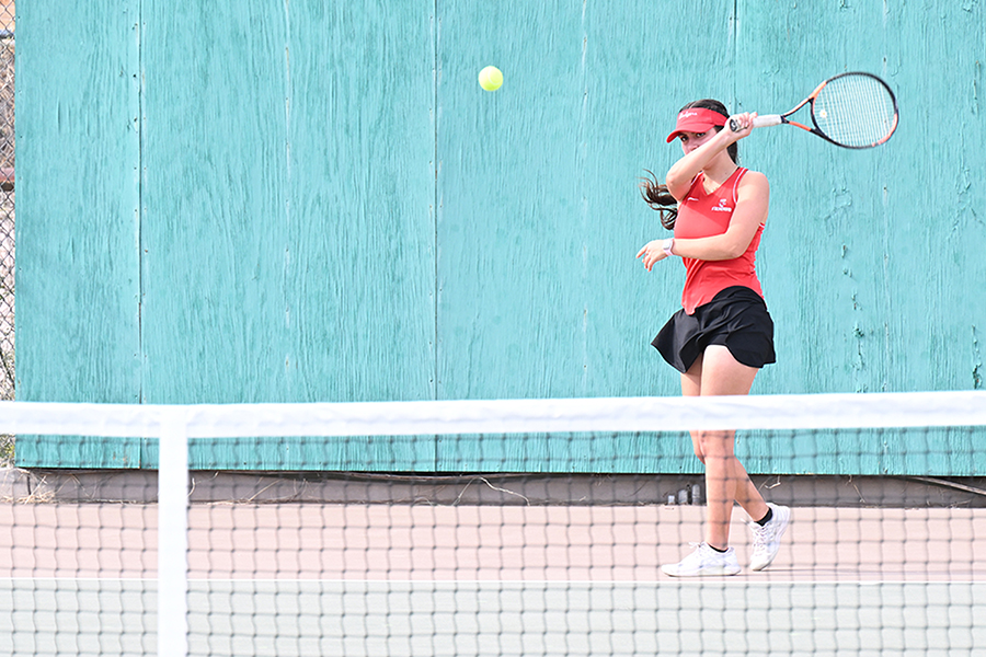 A girl swings her racquet