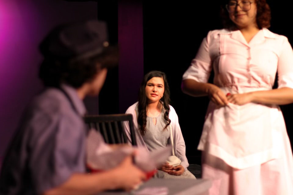 Three teens act on stage