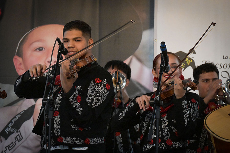 Students play violin during the mariachi performance