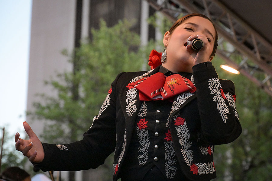 A teen girl sings into the mic