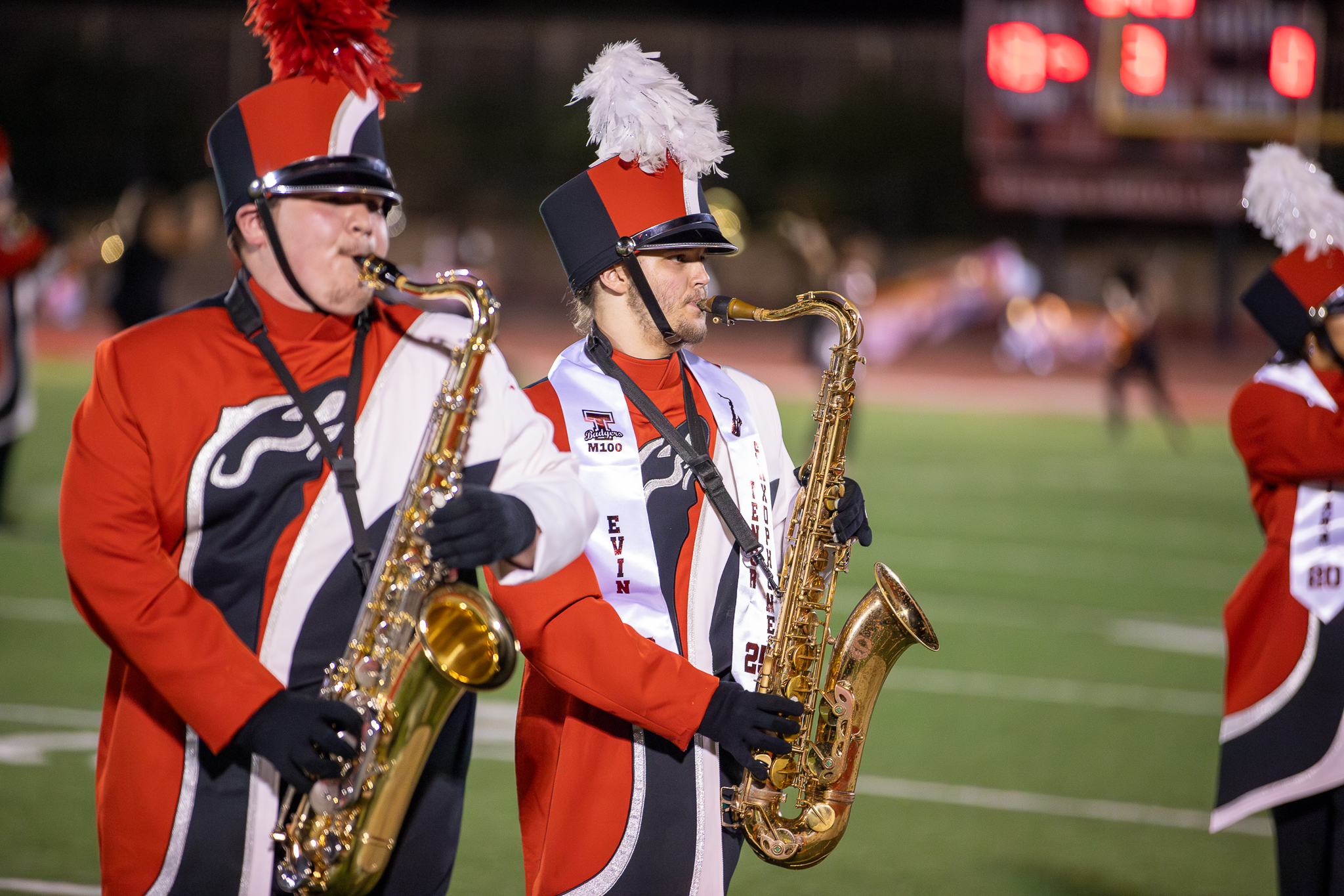 Two tenor saxophone players perform on the field