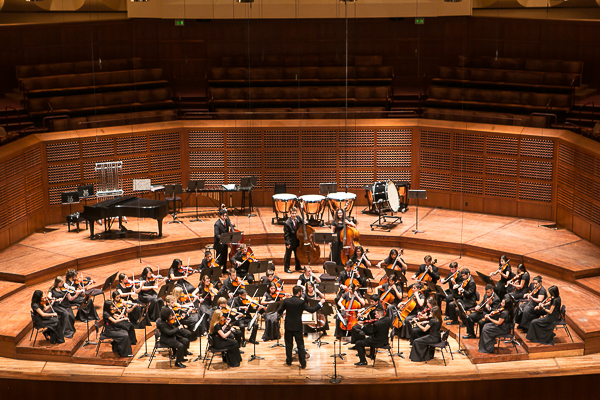 Student orchestra performs.