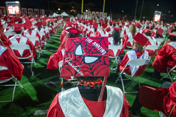 Closeup of a student's cap decorated with Spiderman