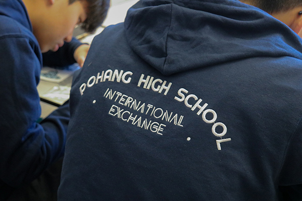 A student wearing a Pohang High School International Exchange sweatshirt