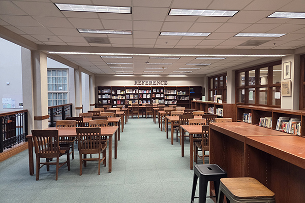 Looking over the table and shelves of the reference section.