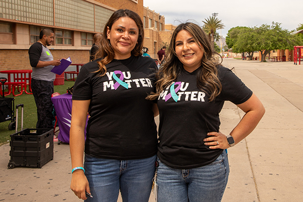Two women smile wearing shirts that read You Matter
