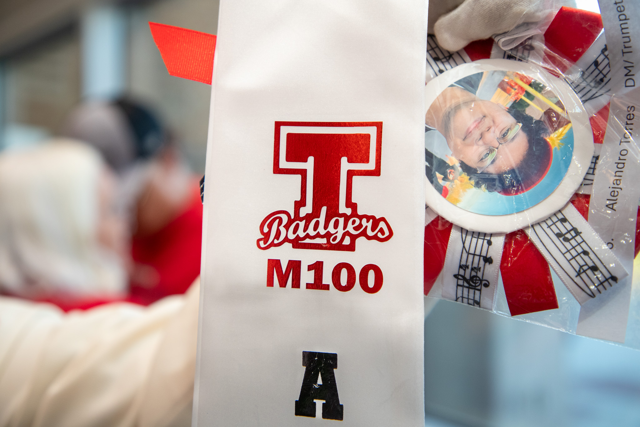 Closeup of a white sash with Tucson Badgers M100 logo