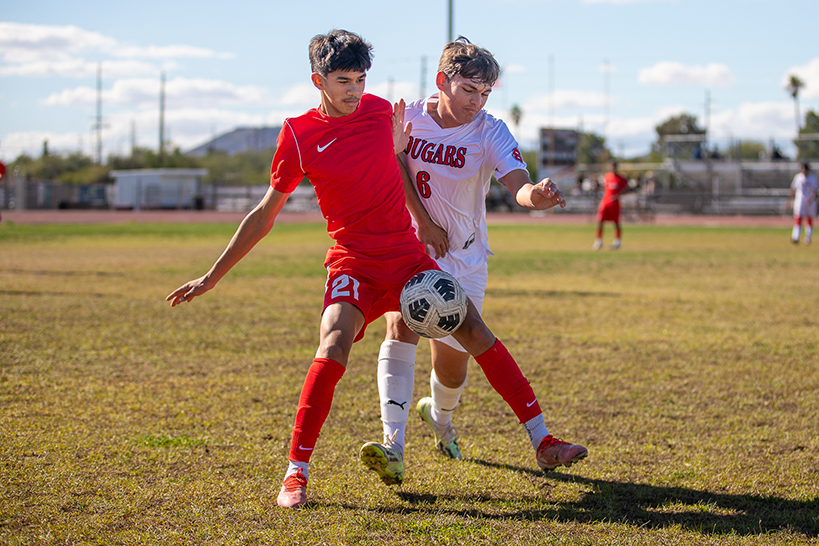 A Tucson High player blocks his Sahuaro opponent from getting to the ball