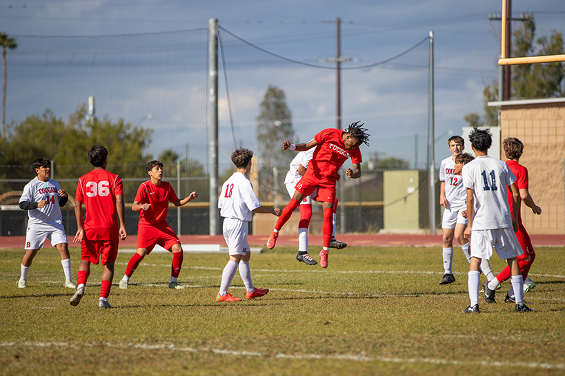 A Tucson High player jumps up to head the soccer ball