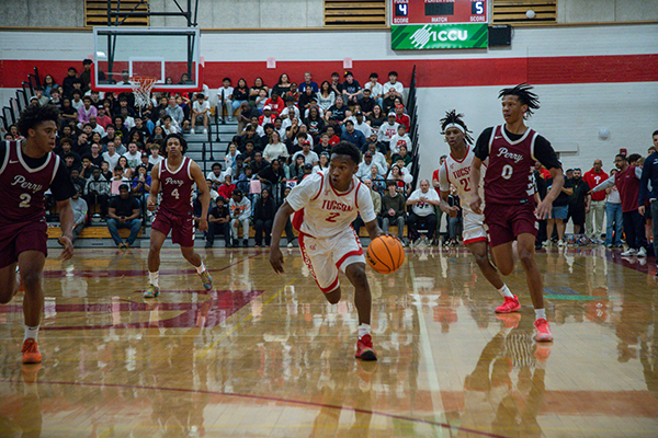A Tucson High player dribbles the ball down the court