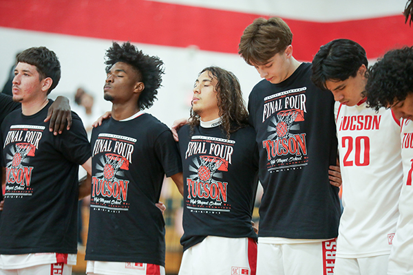 Tucson High players stand in a row before the game