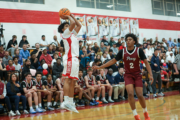 A Tucson High player jumps up to shoot a basket