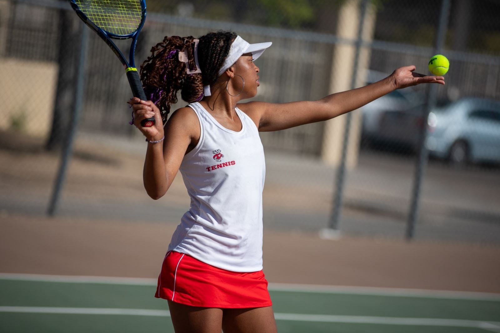 A THMS girls tennis player gets ready to hit the ball over the net.