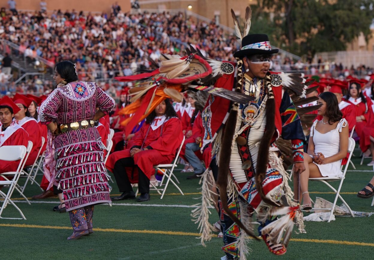 Native American dancers in traditional dress perform during the ceremony